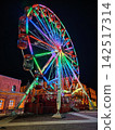 Illuminated Ferris Wheel with Colorful Rainbow LED Lights at Christmas Night on City Square 142517314
