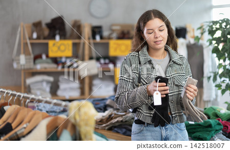 During November sales, young woman choose and buy gloves During November sales, young woman choose and buy gloves 142518007