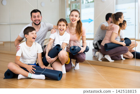 Portrait of happy family at yoga studio 142518815