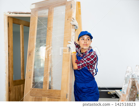 Portrait of female professional door installer in renovated room 142518823