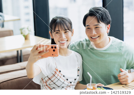 一對年輕情侶在咖啡館自拍 一對年輕情侶在咖啡館自拍 142519329
