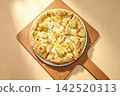 pizza on wooden table 142520313