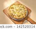 pizza on wooden table 142520314