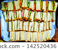 Many sandwiches cut and arranged on a tray 142520436