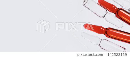 Glass ampoules containing red liquid medicine, representing scientific research and pharmaceutical development Glass ampoules containing red liquid medicine, representing scientific research and pharmaceutical development 142522139