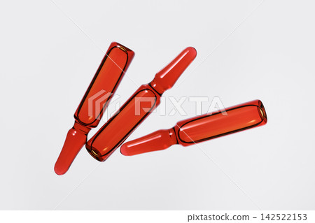 Three medical ampoules with red-orange solution for pharmaceutical use Three medical ampoules with red-orange solution for pharmaceutical use 142522153