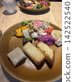 A healthy cafe lunch featuring colorful vegetables and bread. 142522540