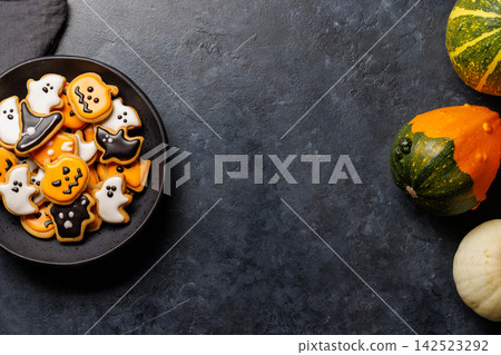 Halloween cookies on black stone background with copy space 142523292