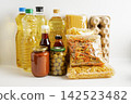 Foodstuff for donation, storage and delivery. Various food, pasta, cooking oil and canned food in cardboard box. 142523482