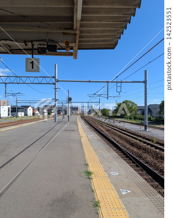 A peaceful rural town train station platform and blue sky A peaceful rural town train station platform and blue sky 142523551