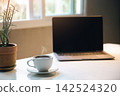 aroma coffee cup on the table with laptop home office in the morning, Energy drink before starting work concept. close up 142524320