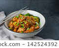 Delicious sweet chopping chicken rice, sesame seeds and sliced spring onions, broccoli, vegetables with chopsticks. Asian food, Japanese food copy space for your text 142524392