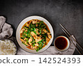 Tasty Stir-fried pork and red hot curry paste with long bean Ingredients are oyster sauce, fish sauce, sugar, and kaffir lime leaves in the dish Eat with cooked rice. Thai cuisine top view 142524393