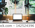 Mockup laptop devices home office. personal computer notebook white screen. and coffee cup, houseplant, notepaper as a desk in the morning 142524396