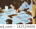Business Meeting with graph, Growth Analysis report take note Chart on statistics data finance business Presentation to teamwork communication online team of employees discussing financial statistics 142524408