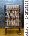 Fresh Raw Sausages Hanging on Racks in Food Processing Factory 142525198
