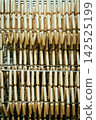 Fresh Raw Sausages Hanging on Racks in Food Processing Factory 142525199