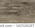 Weathered driftwood texture with fine sand grains. Aged natural wood background ideal for eco branding, beach themes, and rustic web design 142526287