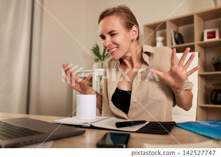 Emotional woman gesturing during online video call at home office desk Emotional woman gesturing during online video call at home office desk 142527747