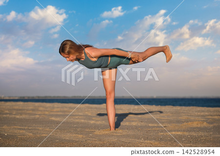Virabhadrasana 3 yoga variation with arms reaching backward Virabhadrasana 3 yoga variation with arms reaching backward 142528954
