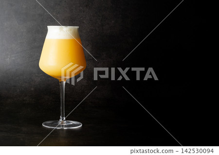 A cloudy American craft beer, Hazy IPA (Newing) poured into a glass. A cloudy American craft beer, Hazy IPA (Newing) poured into a glass. 142530094