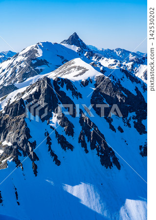 Views of the Daikiretto and Mt. Yarigatake from Kitahotaka Hut: Climbing Mt. Kitahotaka in the Northern Alps during early summer when snow remains. Views of the Daikiretto and Mt. Yarigatake from Kitahotaka Hut: Climbing Mt. Kitahotaka in the Northern Alps during early summer when snow remains. 142530202