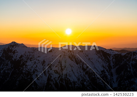 The sunset (magic hour) over the Hida Mountains (Mt. Kasagatake) as seen from Kitahotaka Hut. A climb of Mt. Kitahotaka in the Northern Alps during early summer when snow remains. The sunset (magic hour) over the Hida Mountains (Mt. Kasagatake) as seen from Kitahotaka Hut. A climb of Mt. Kitahotaka in the Northern Alps during early summer when snow remains. 142530223