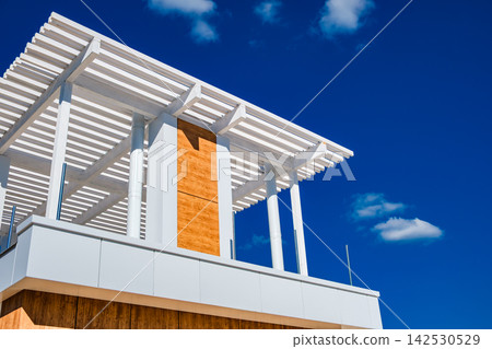 recreation area on the second floor of the house against the background of the sky recreation area on the second floor of the house against the background of the sky 142530529