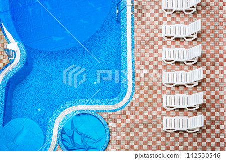 swimming pool and deck chairs, top view swimming pool and deck chairs, top view 142530546