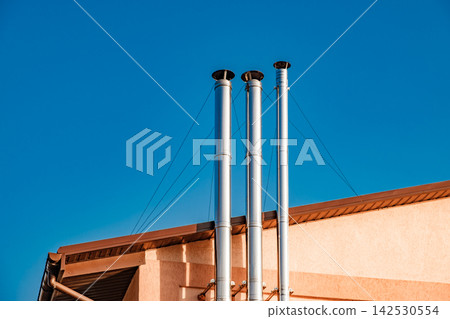 Shiny metal chimneys against the sky Shiny metal chimneys against the sky 142530554