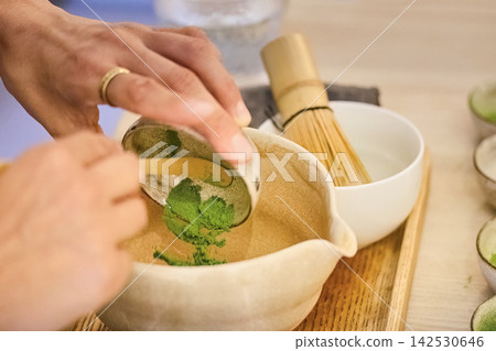 Hands preparing matcha green tea for traditional ceremony Hands preparing matcha green tea for traditional ceremony 142530646