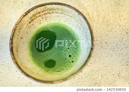Matcha green tea in ceramic bowl preparing healthy drink 142530650