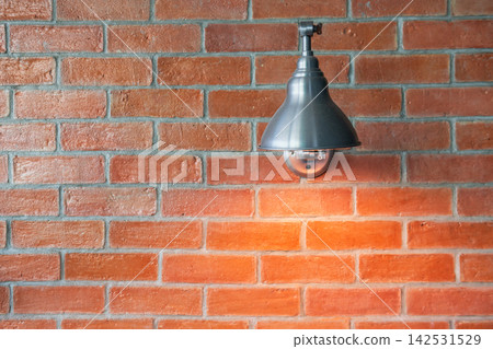 brick wall illuminated by modern lamp light up at night brick wall illuminated by modern lamp light up at night 142531529