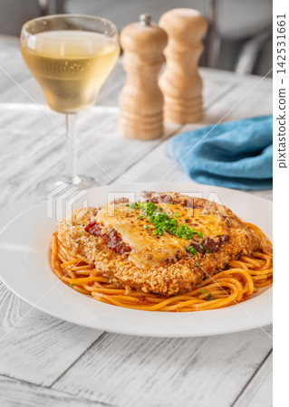Chicken Parmesan with spaghetti white wine and Italian bistro table setting breakfast Chicken Parmesan with spaghetti white wine and Italian bistro table setting breakfast 142531661