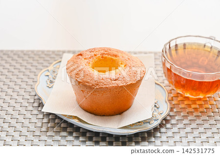 Enjoy a café time at home with chiffon cake and tea. Enjoy a café time at home with chiffon cake and tea. 142531775