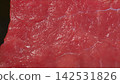 Extreme macro shot of fresh raw beef meat surface, glistening red muscle fibers and fine connective tissue texture 142531826