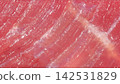 Macro full frame shot of raw beef muscle grain texture, fine marbling connective tissue and glistening red meat fibers 142531829