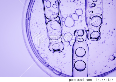 Pipettes with cosmetic liquid against background of Petri dish Pipettes with cosmetic liquid against background of Petri dish 142532187