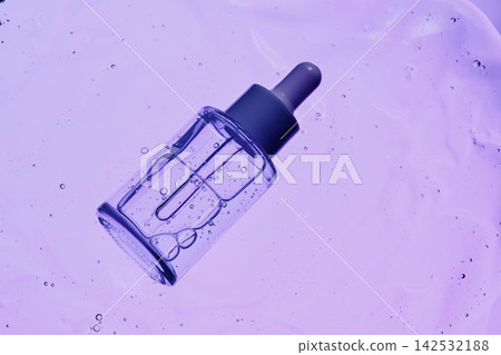 Clear cosmetic liquid inside glass bottle with dropper amidst textured gel and bubbles Clear cosmetic liquid inside glass bottle with dropper amidst textured gel and bubbles 142532188