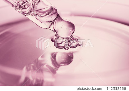 Pipette dropper extracting fluid from smooth liquid surface, indicating beauty and science Pipette dropper extracting fluid from smooth liquid surface, indicating beauty and science 142532266