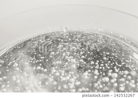 Carbonated liquid forming many small bubbles inside glass Carbonated liquid forming many small bubbles inside glass 142532267