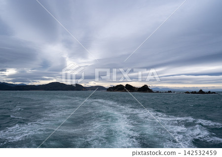 Islands as seen from a sightseeing boat in Toba Bay 142532459