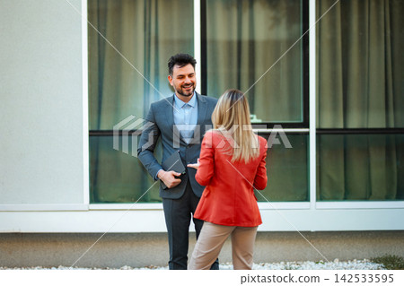 Business colleagues meeting outside discussing work and collaboration Business colleagues meeting outside discussing work and collaboration 142533595