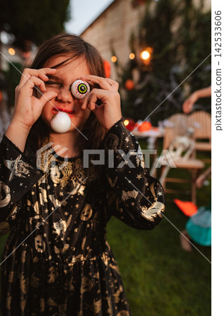 Child celebrating Halloween playing with toy eyeballs Child celebrating Halloween playing with toy eyeballs 142533606