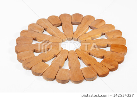 Circular bamboo trivet with radial pattern on white background Circular bamboo trivet with radial pattern on white background 142534327