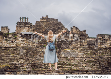 Woman traveler walking among ancient stone terraces at Tonina Maya ruins in Chiapas Mexico with pre Hispanic history stone walls cultural heritage Mexican archaeology and close up. Woman traveler walking among ancient stone terraces at Tonina Maya ruins in Chiapas Mexico with pre Hispanic history stone walls cultural heritage Mexican archaeology and close up. 142535067