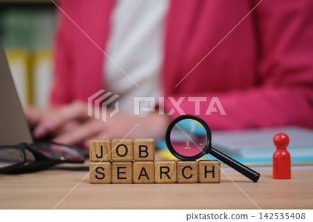 Exploring new opportunities with a job search and focused determination in a bright office setting Exploring new opportunities with a job search and focused determination in a bright office setting 142535408