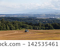 A tractor running through a farming area 142535461