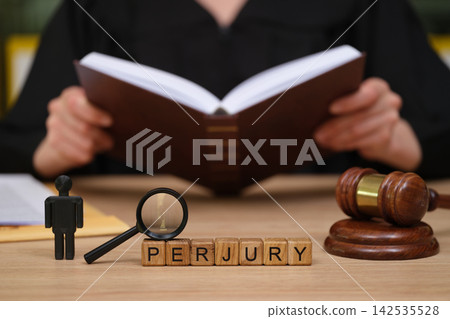 Courtroom scene highlighting the seriousness of perjury with a judge preparing for an important case Courtroom scene highlighting the seriousness of perjury with a judge preparing for an important case 142535528