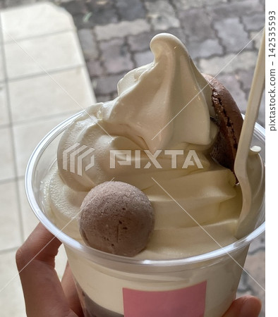Soft serve ice cream topped with baked goods from a cake shop. 142535593